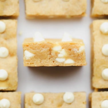 baked blondies with white chocolate chips cut into squares