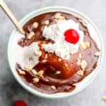 square image of ice cream with fudge and a cherry