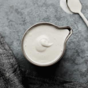 square image of cream in a grey pitcher