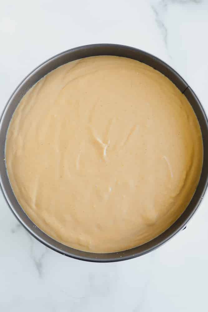 A light brown creamy mixture in a round metal pan.