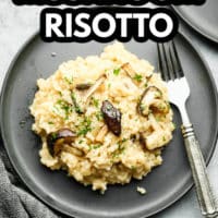 pinterest image of a scoop of creamy risotto topped with cooked mushrooms on a grey plate with a fork.