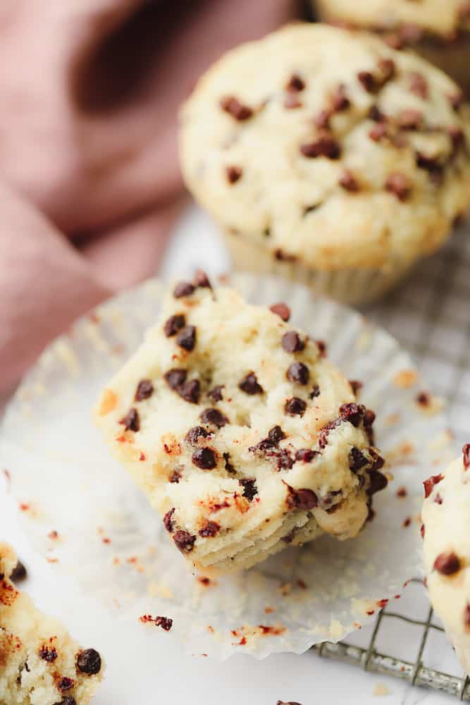 open chocolate chip muffin showing fluffy center filled with chocolate chips