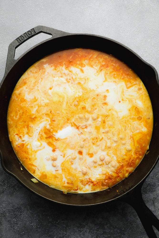 large black skillet filled with a creamy orange liquid.