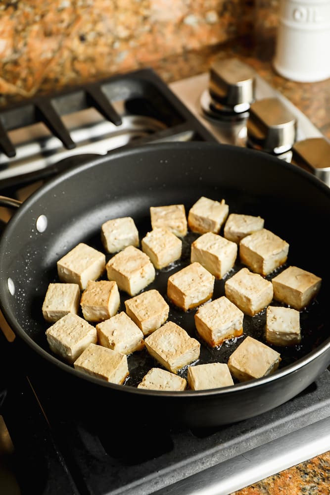pan on stovetop frying tofu