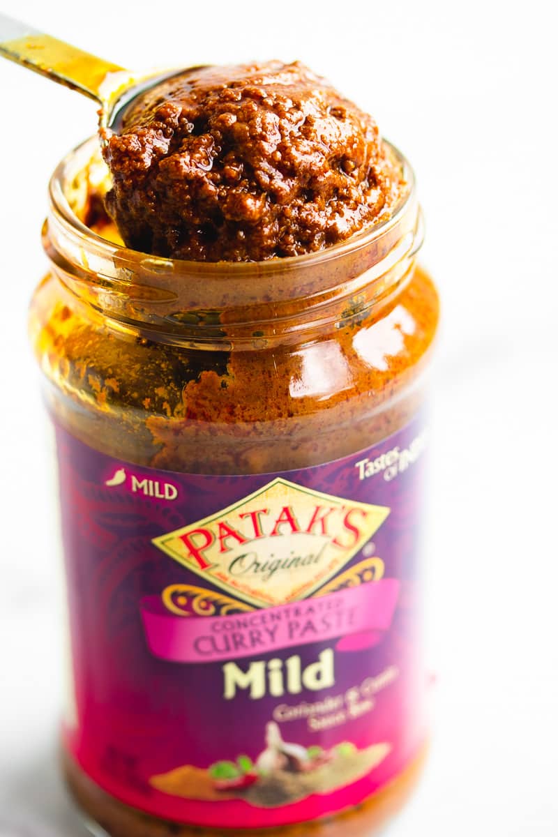 curry paste in a jar with a tablespoon