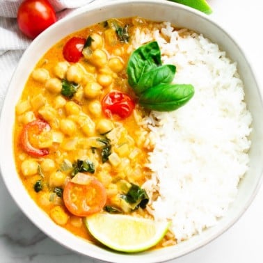 square image of curry in a bowl with rice