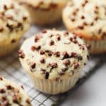 square image of a vegan chocolate chip muffin with more in background