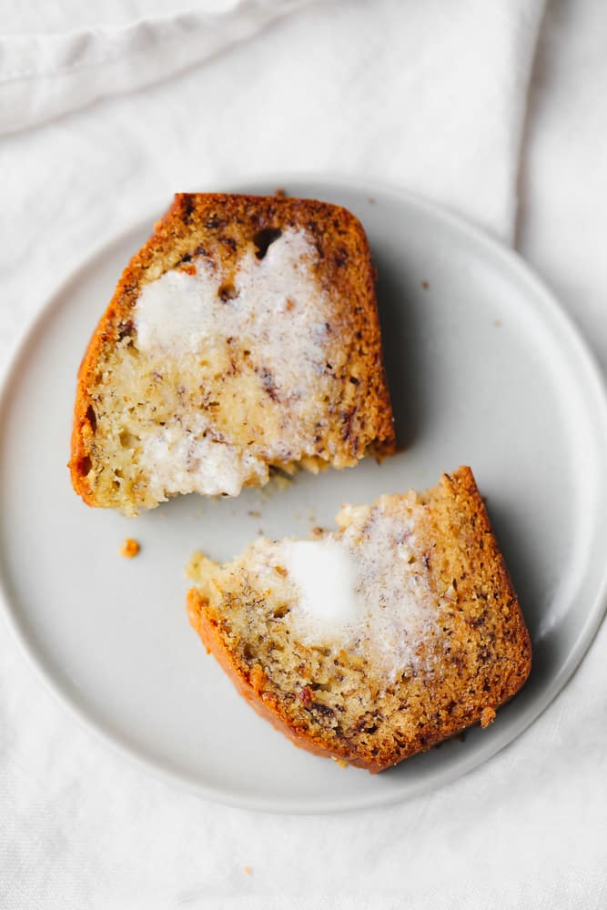 cut in half piece of bread with butter all over it