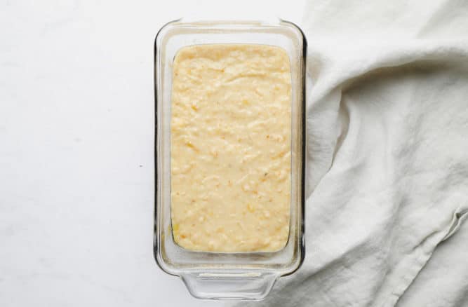 uncooked yellow batter in glass pan