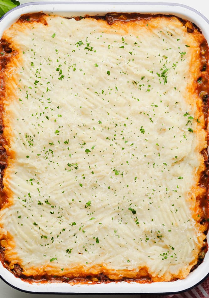 whole uncut vegan shepherd's pie in a white pan