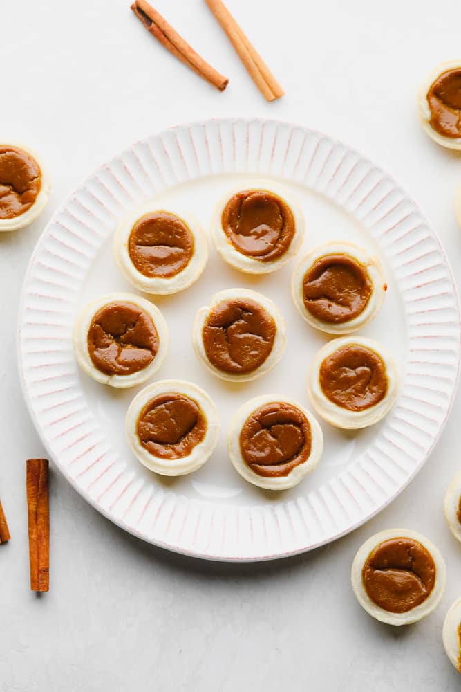 little pumpkin pies without whipped cream on a plate