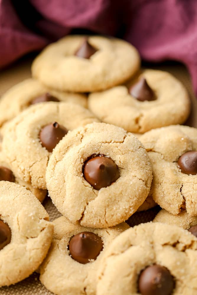 lots of peanut butter kiss cookies with purple towel