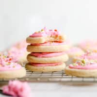 square image of stacked sugar cookies on rack