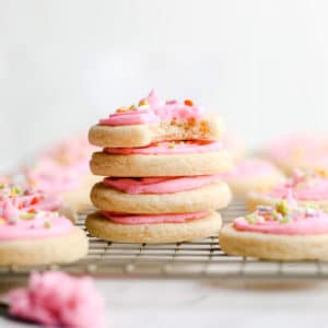 square image of stacked sugar cookies on rack