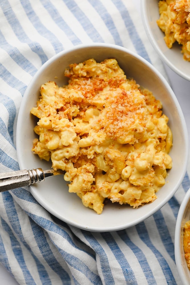 bowl of mac and cheese with blue striped towel