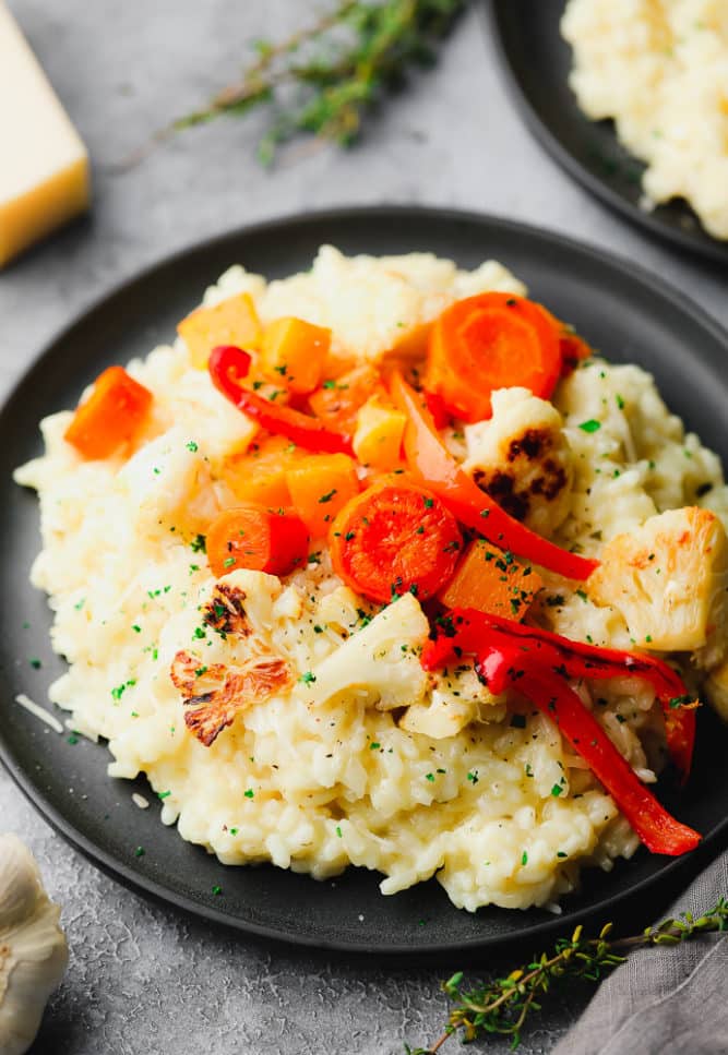 close up of risotto with lots of vegetables on top