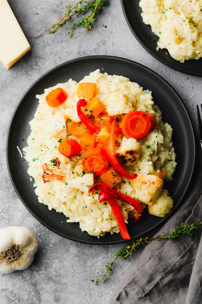 looking down on a plate of vegan risotto with vegetables on top