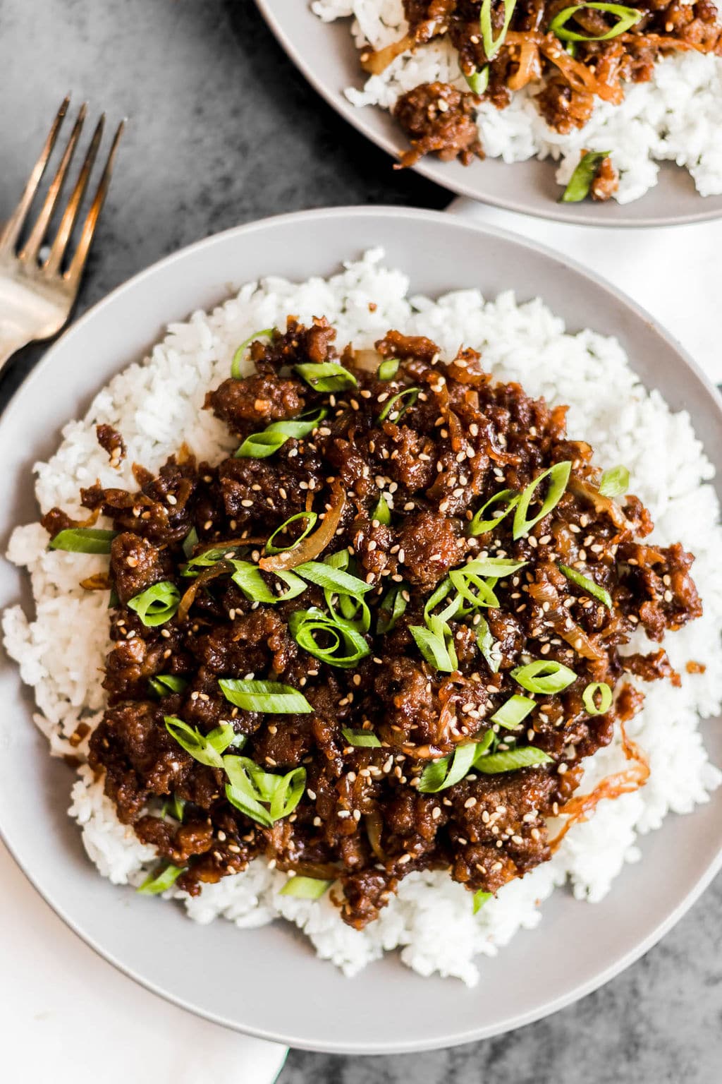 white rice and cooked ground vegan beef on a white plate.