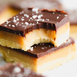 close up on a millionaire shortbread bar with a bite out of it.