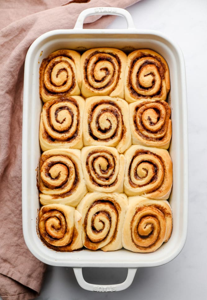 cooked cinnamon rolls with pink towel, no frosting