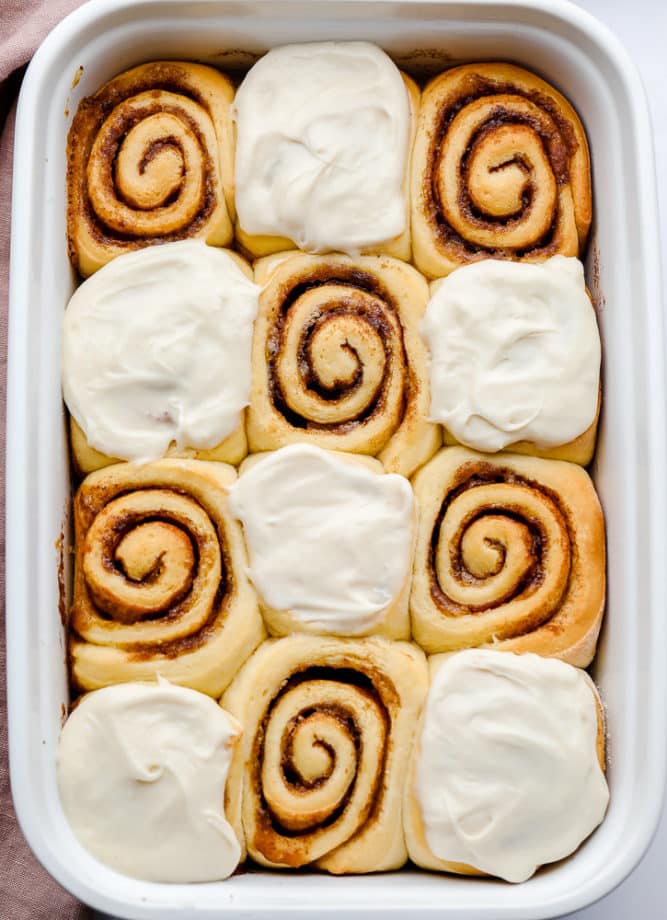 rolls in a dish, half with frosting