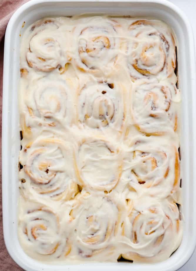 looking down on large plate of frosting covered rolls