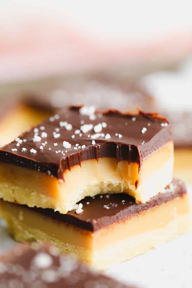 close up on a millionaire shortbread bar with a bite out of it.