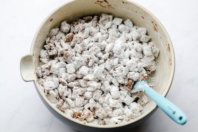 showing mixing of chocolate and powdered sugar with cereal in bowl