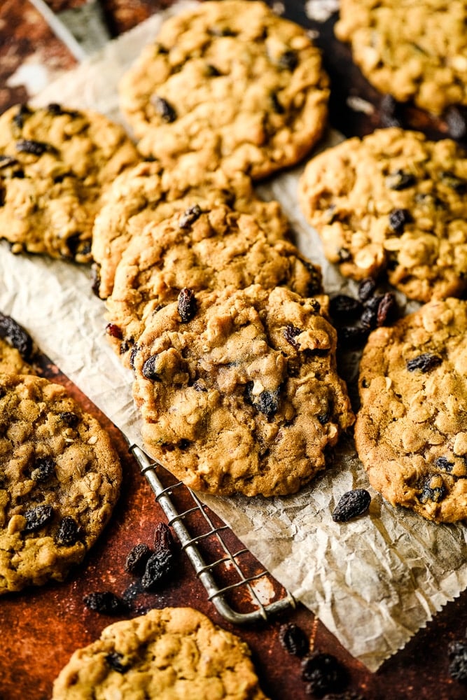 lots of cookies on cooling rack with some raisins around it