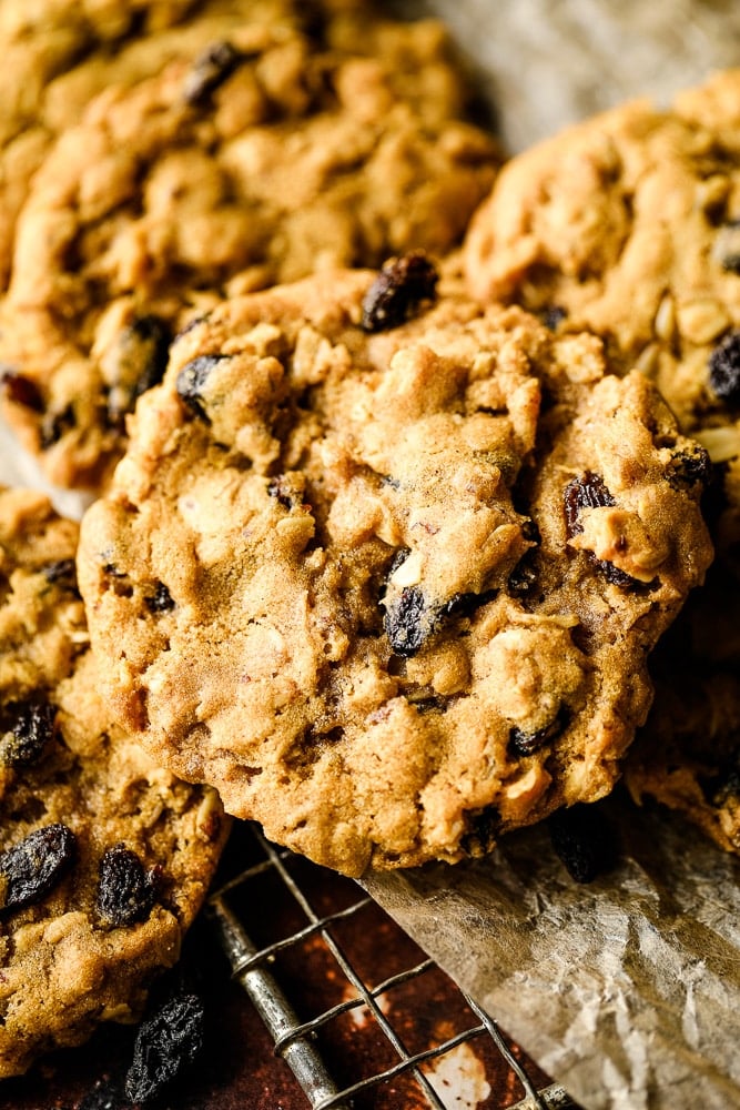 close up of a raisin oatmeal cookie on rack