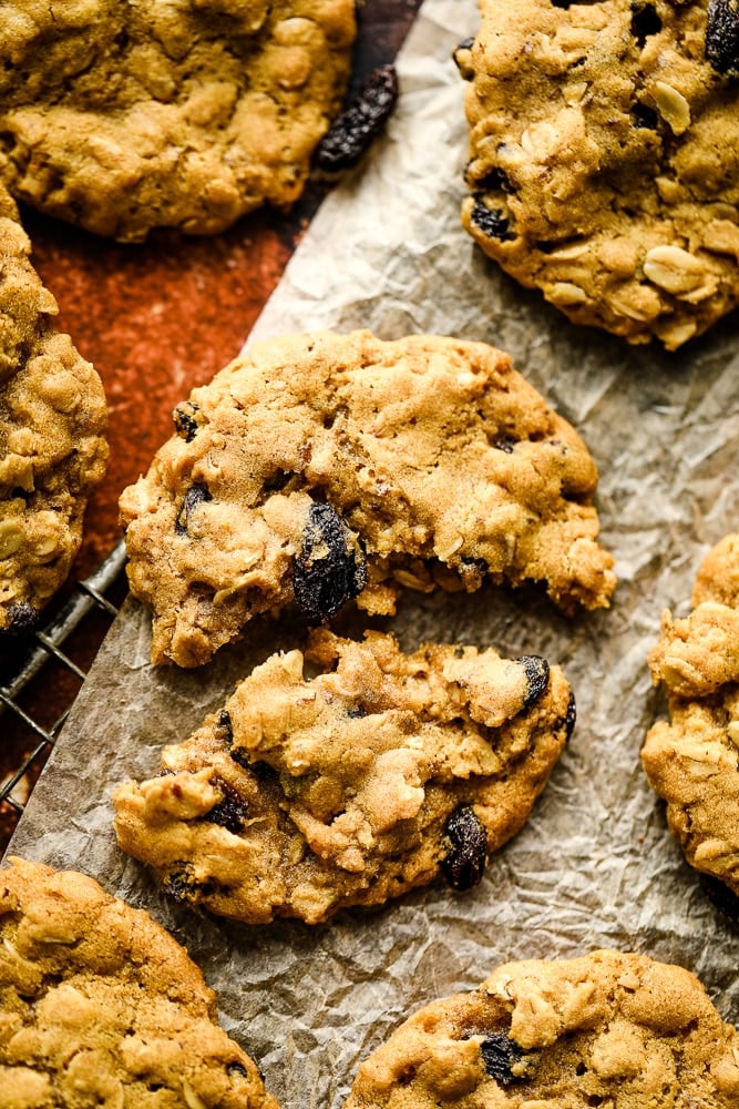 broken cookie on parchment paper with more cookies around it