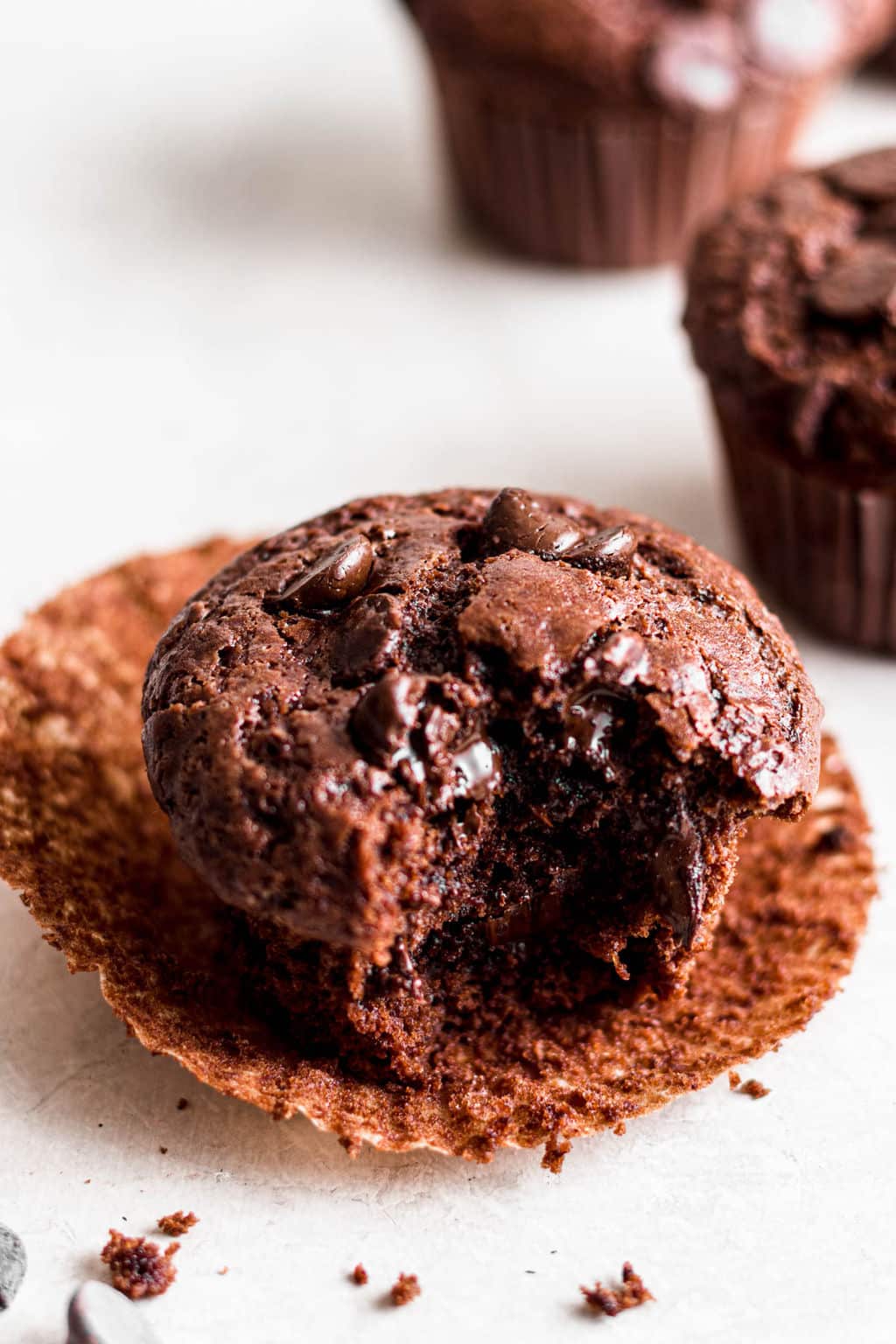 vegan chocolate muffin with a bite out of it.