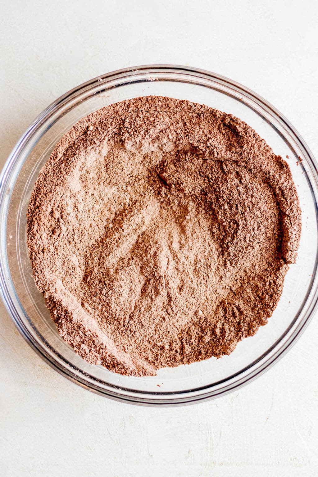 dry baking ingredients and cocoa powder in a glass bowl.