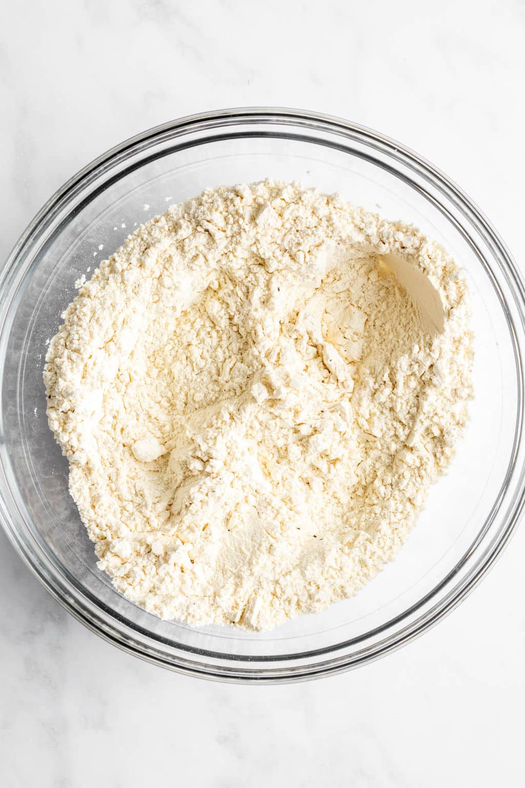 large glass bowl filled with flour.