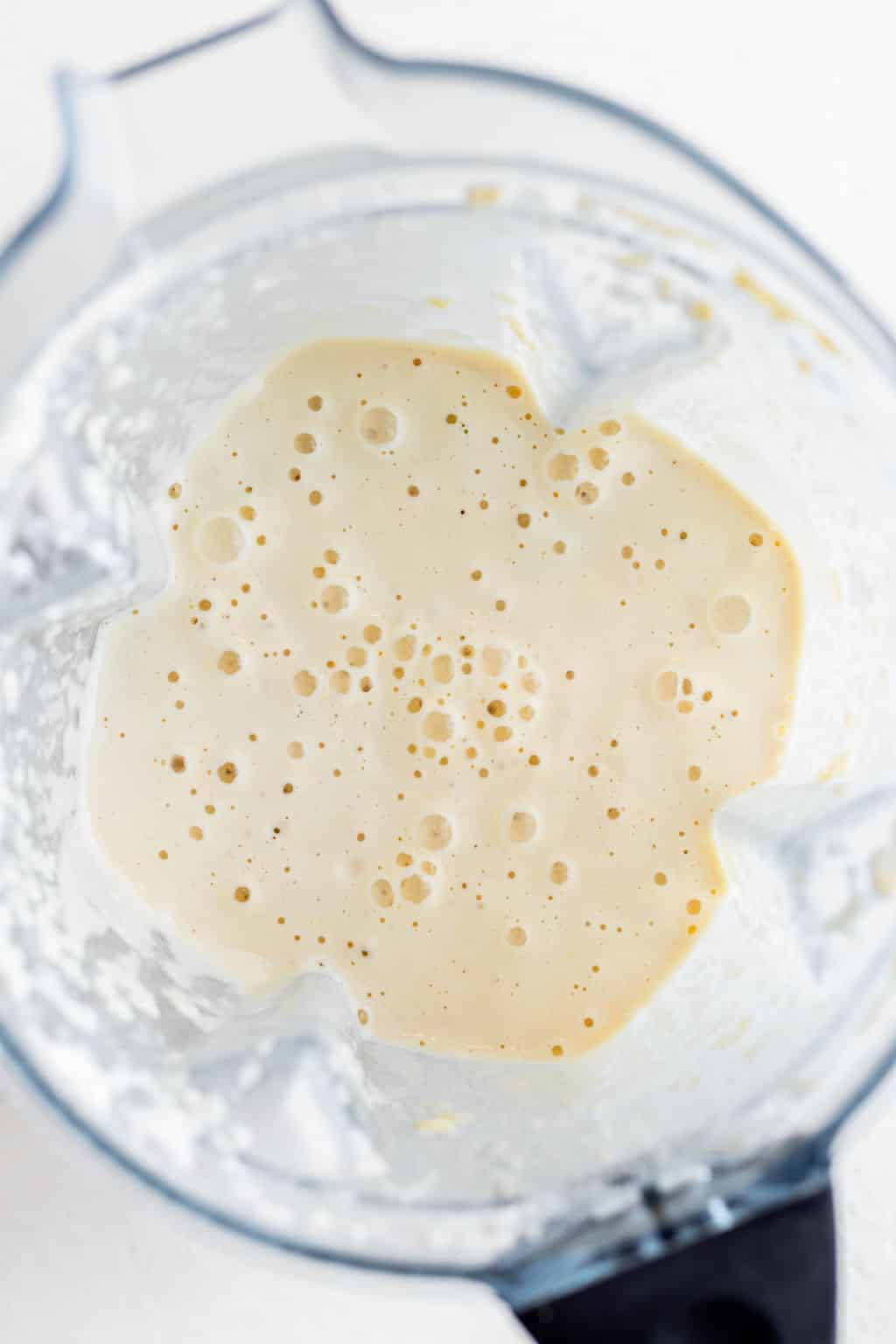 creamy white liquid in a blender.