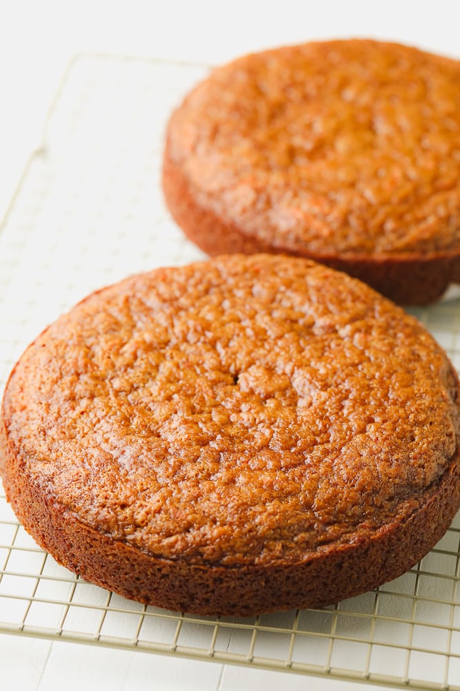 two layer carrot cake on cooling rack, no frosting