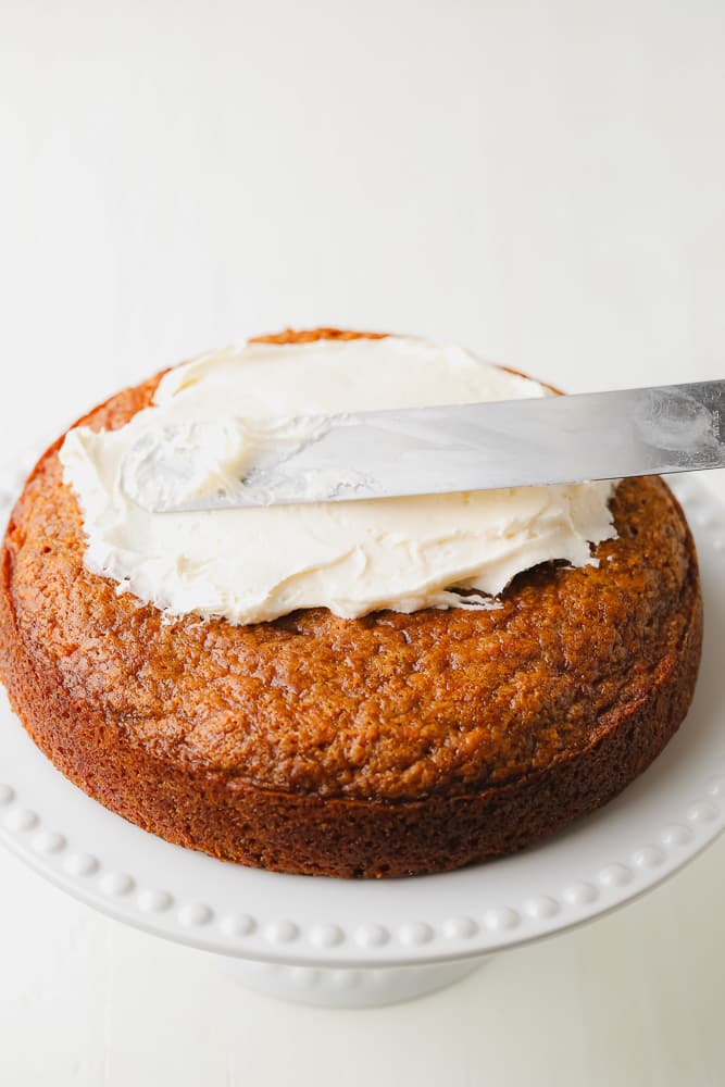 frosting being spread on a cake