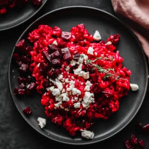 black plate with red rice, cheese and beets