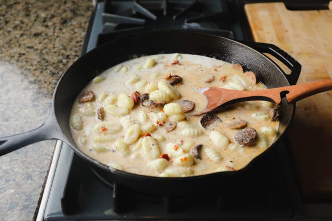 pan full of little pasta and sausage, creamy sauce