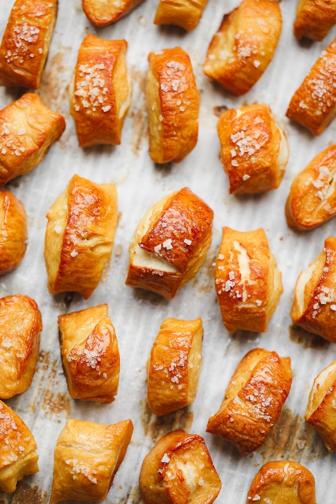 a pan full of baked golden small pretzels with coarse salt