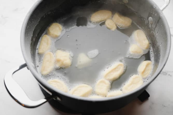 pot with dough floating in some water