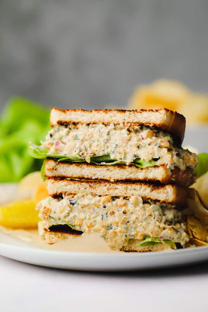 sandwich filled with vegan tuna and lettuce, stacked halves on top of each other