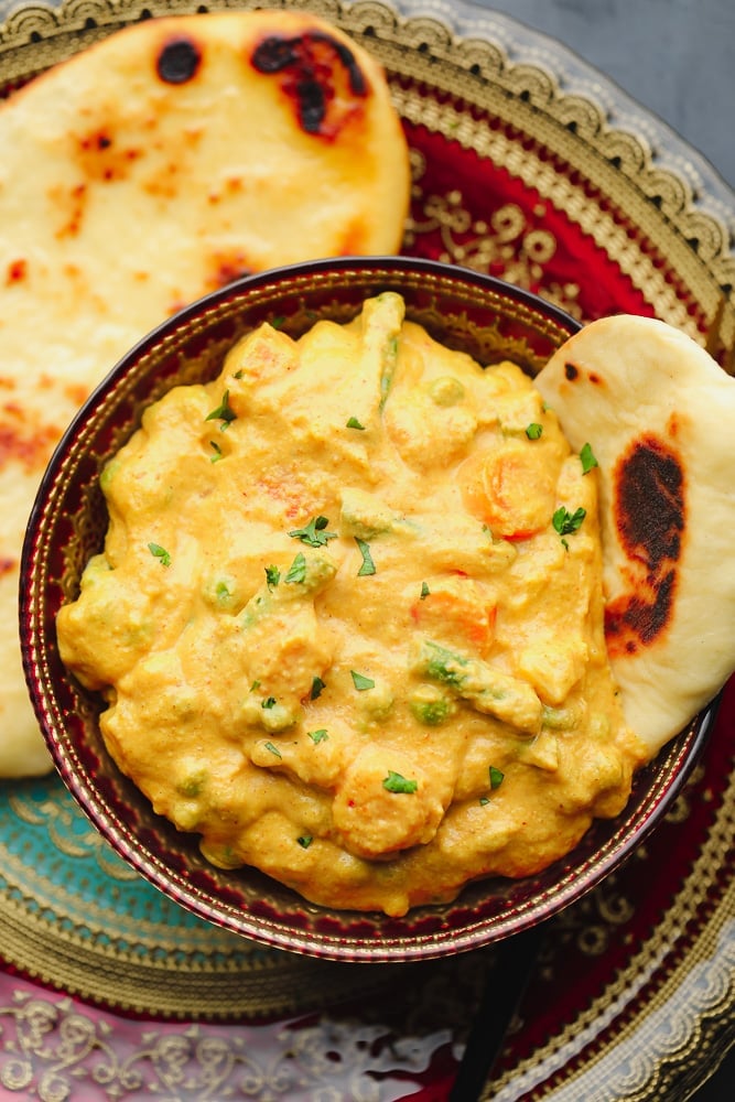 plate with naan and a bowl with curry on it