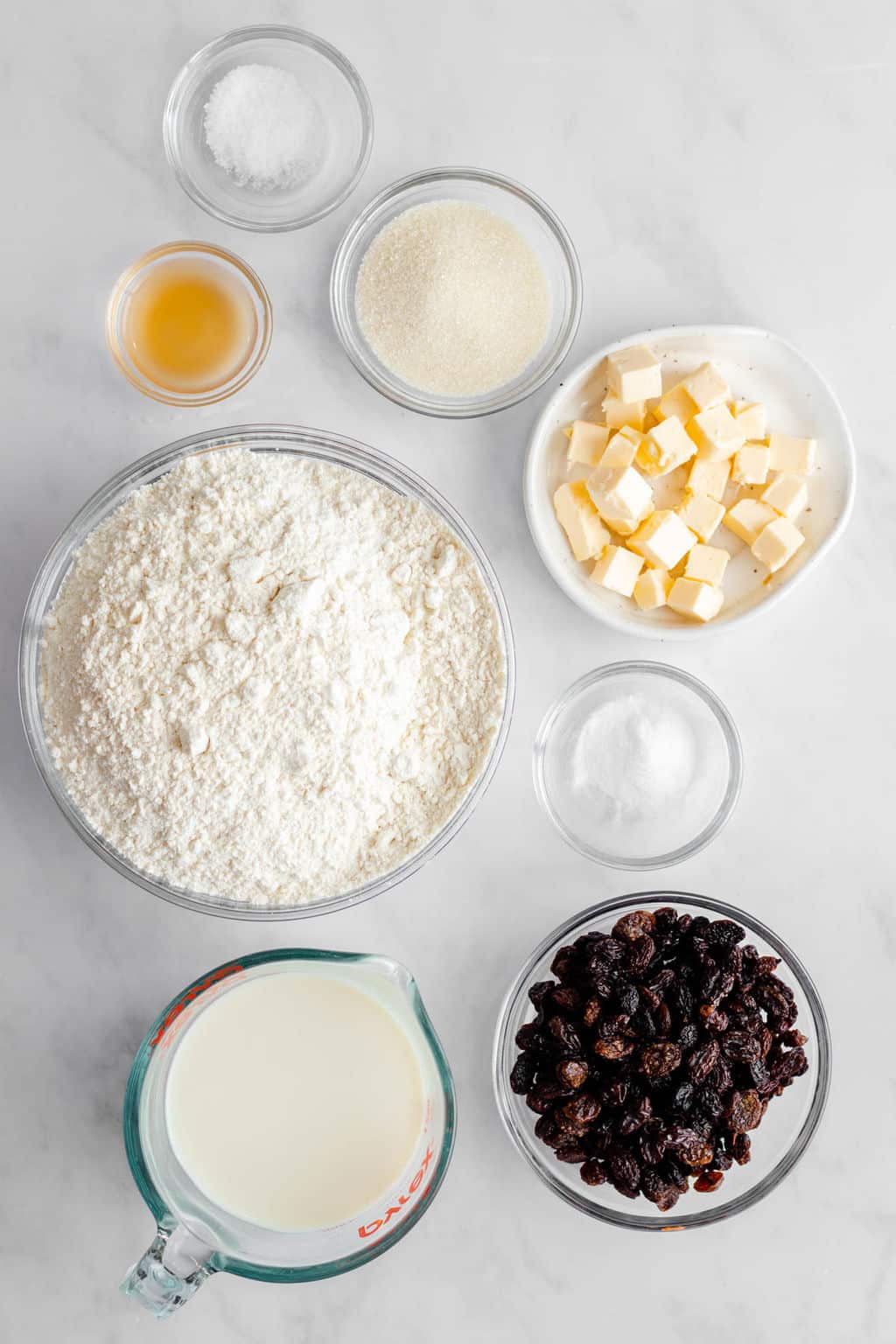 The ingredients for vegan Irish soda bread in individual glass bowls.