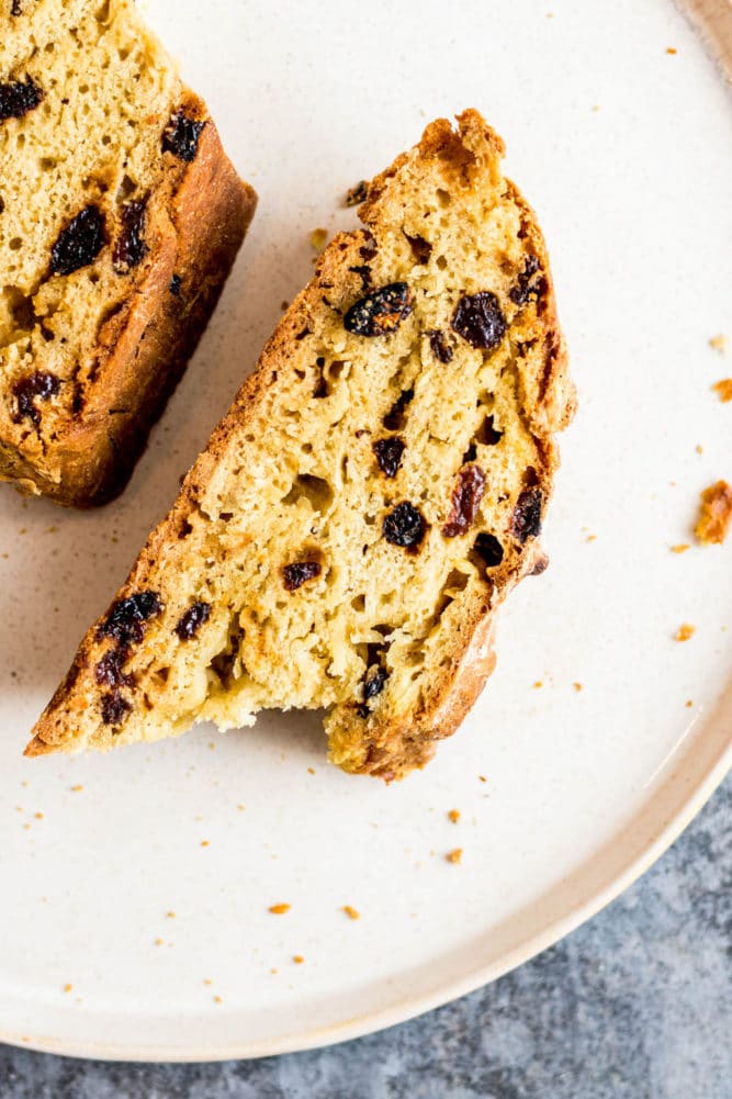 a slice of vegan Irish soda bread on a white plate.