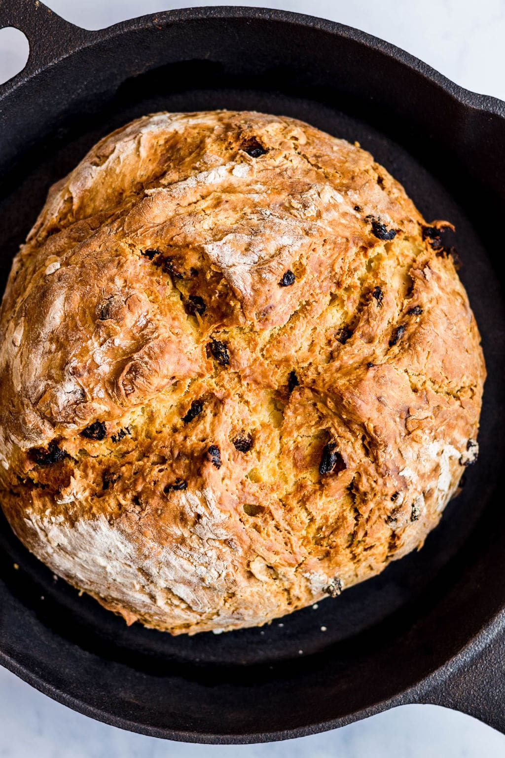 baked vegan Irish soda bread in a black cast iron pan.