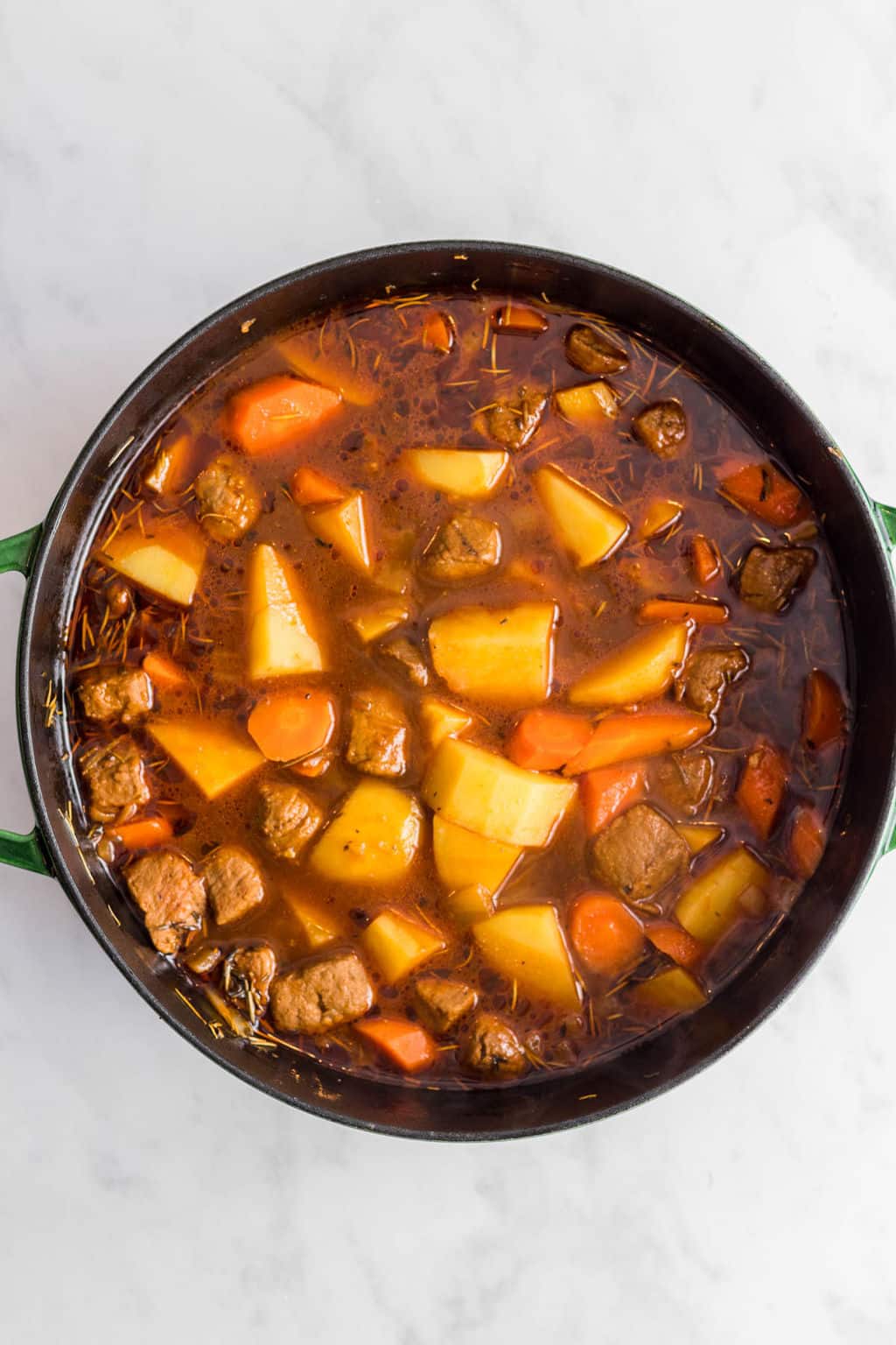 cooking vegan irish stew in a large pot.