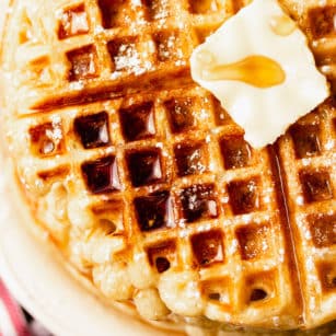 square image of waffles with butter and syrup, close up