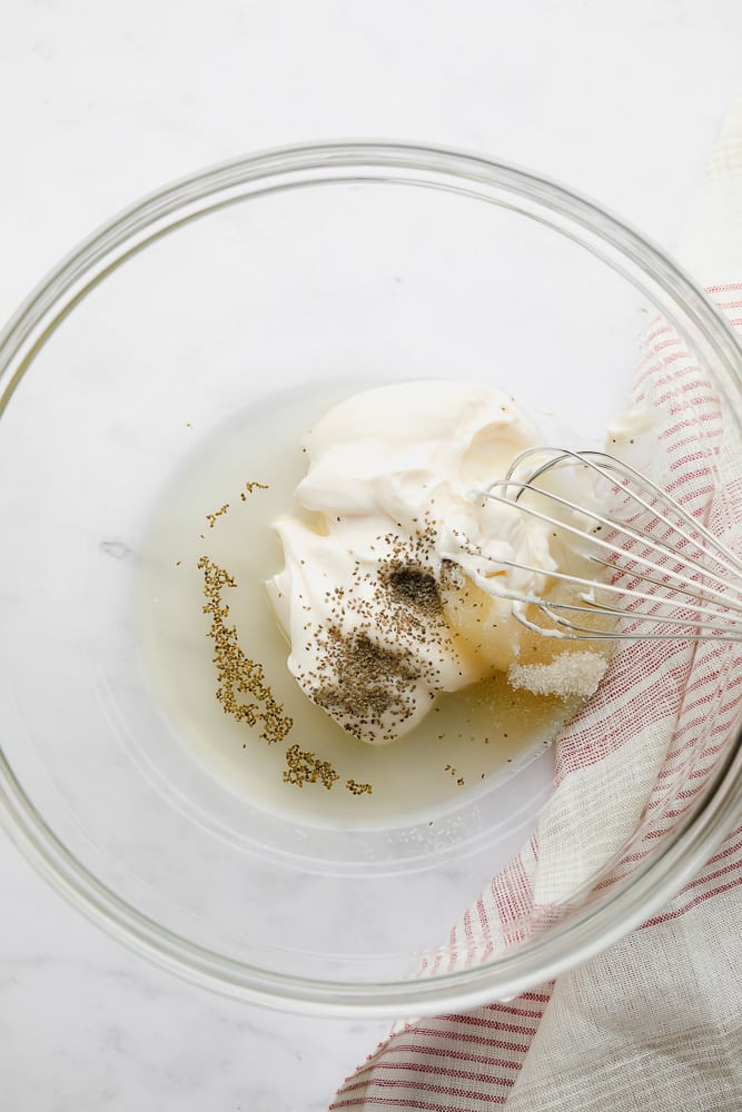 glass bowl with mayo and other ingredients before being mixed