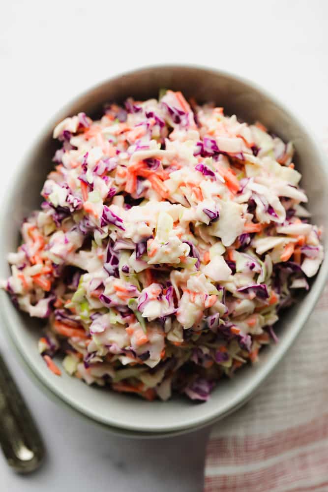 close up bowl of coleslaw with towel red and white